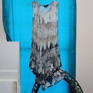 Riviera sun, gray and white dress, very flowy, embroidered designs.